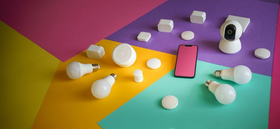 Various IoT devices — smart bulbs, sensors, camera and smartphone